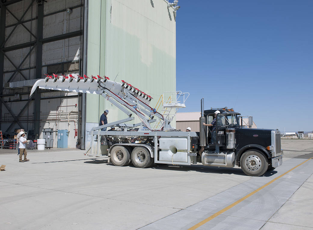 HEIST’s modified wing is lifted into position after being mounted on a big rig.