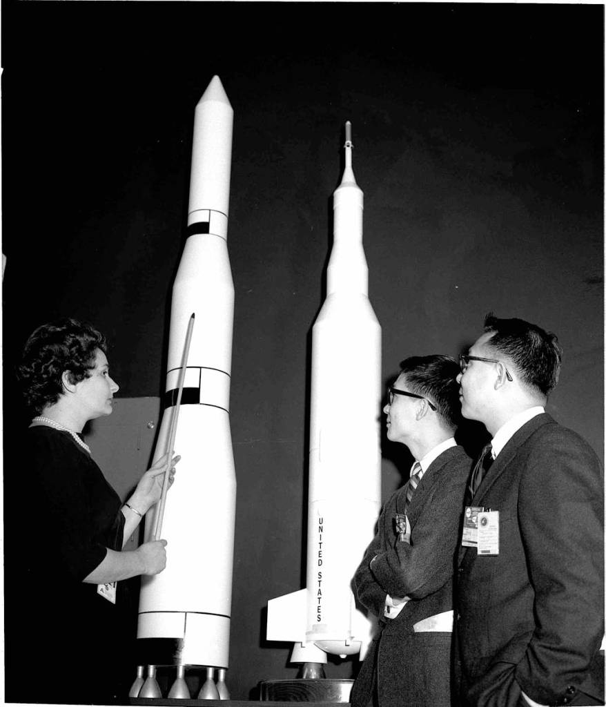 Evelyn Falkowski with Japanese visitors William Tung and Joseph Tung in the Space Orientation Center at Marshall.