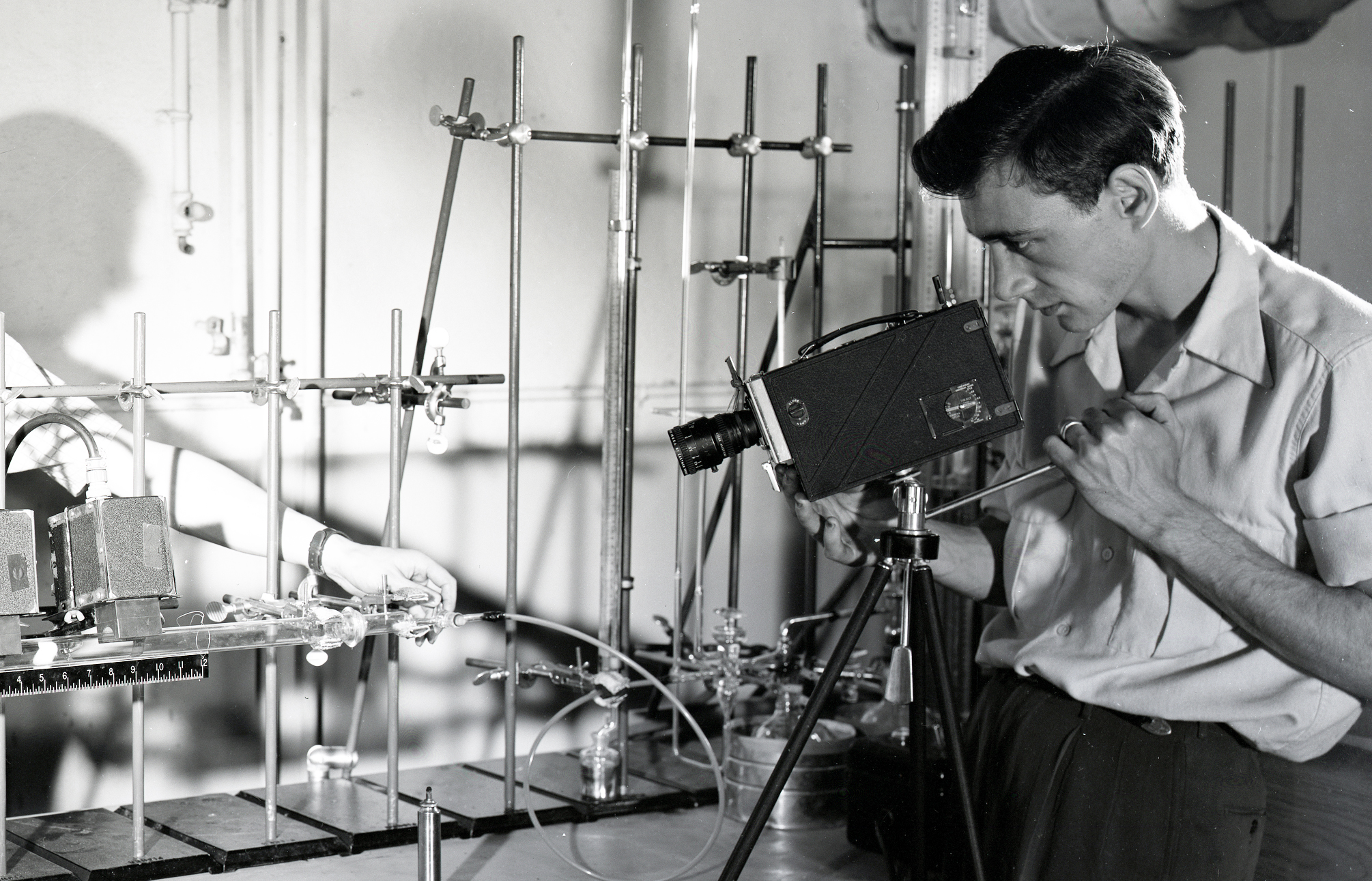 Photographer filming table-top experiment.