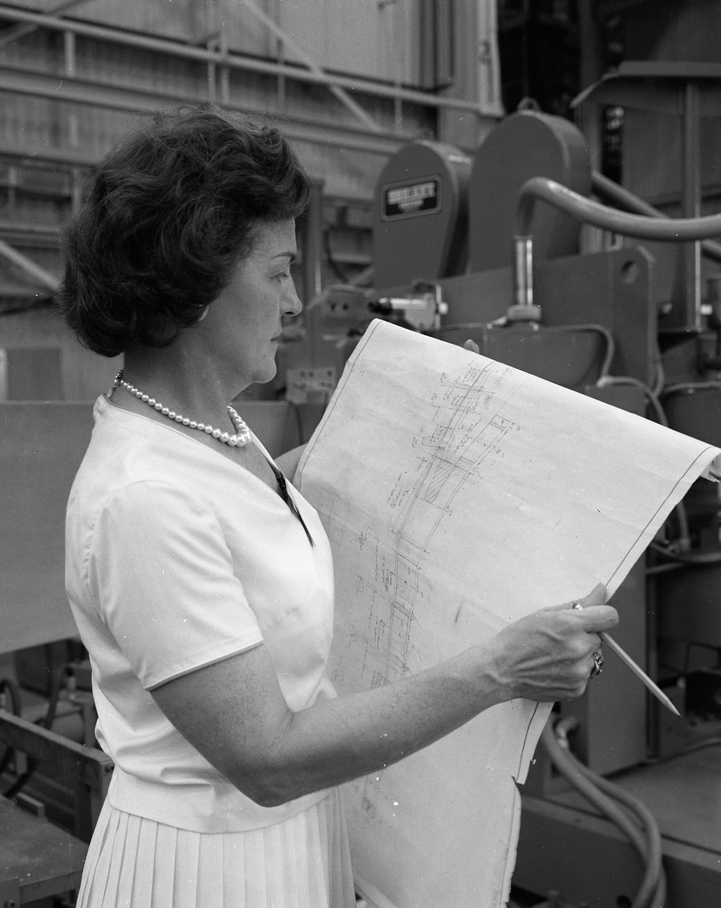 Margaret W. ‘Hap’ Brennecke reviews blueprints in the Manufacturing and Engineering Laboratory at Marshall Space Flight Center.