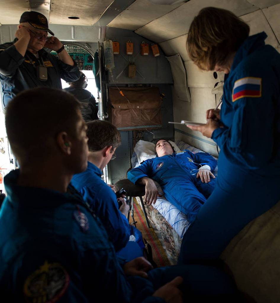 An ISS crewmember receives medical care onboard a helicopter.