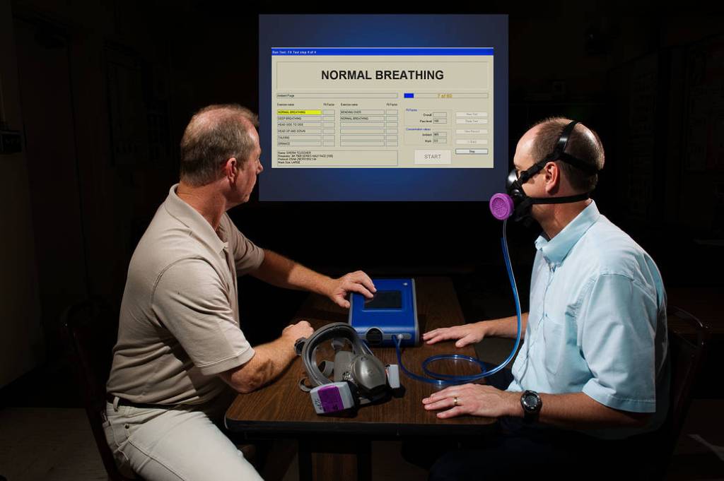 An Industrial Hygienist conducts a fit test on a respirator user in the Occupational Health Office