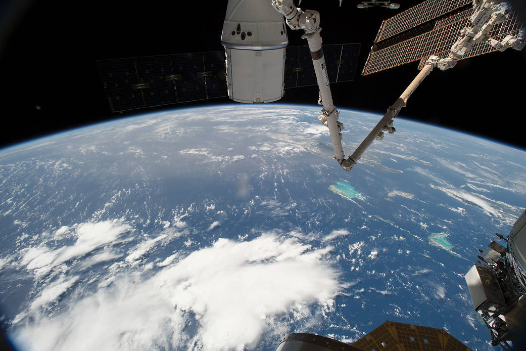The SpaceX Dragon and the International Space Station orbit above the Bahamas