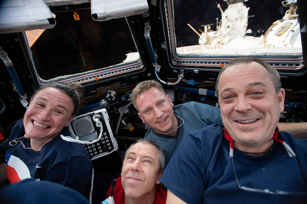 Four Expedition 56 crew members gather inside the Cupola