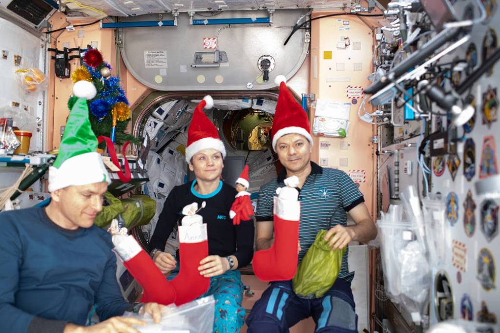 The Expedition 58 crew opens stockings on Christmas Day