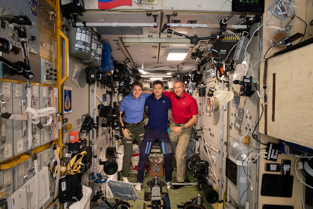 Expedition 58 crew members gather inside the Zvezda service module