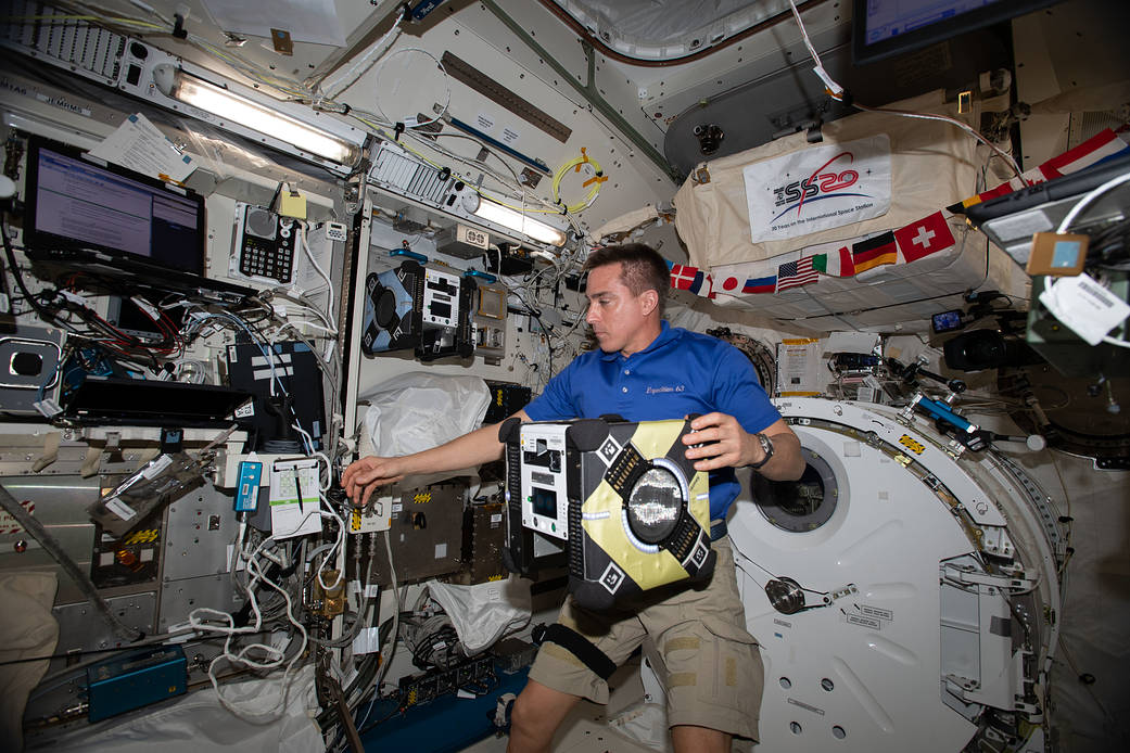 Expedition 63 Commander Chris Cassidy sets up an Astrobee robotic assistant