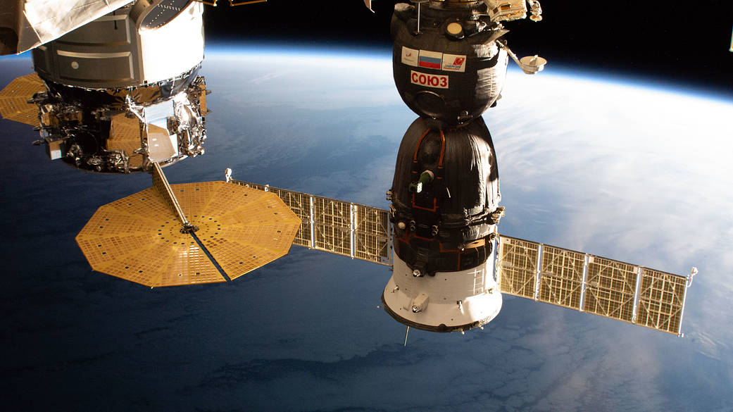 The Cygnus and Soyuz spaceships are pictured attached to the station