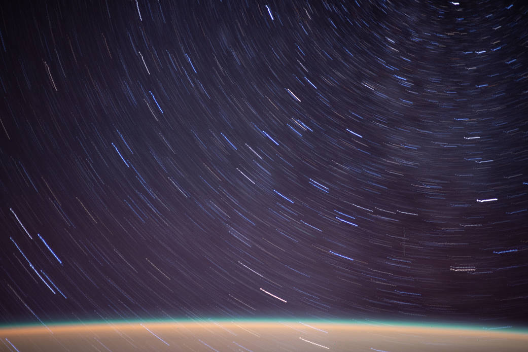 Streaks of a starry field above Earth