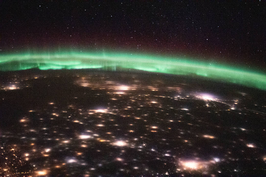 City lights and an aurora above Russia