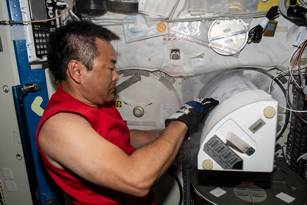 JAXA astronaut Akihiko Hoshide opens a science freezer