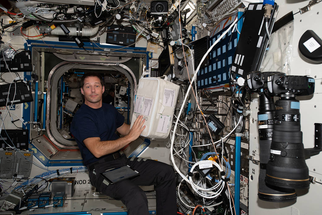 ESA astronaut Thomas Pesquet gathers science hardware