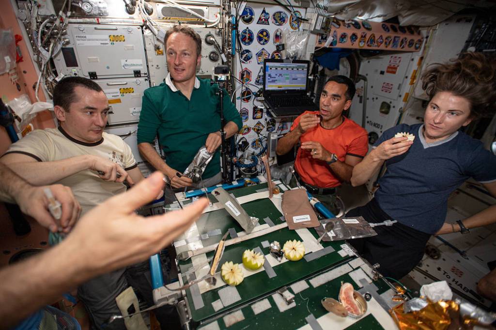 Expedition 66 crew members gather for a Thanksgiving meal