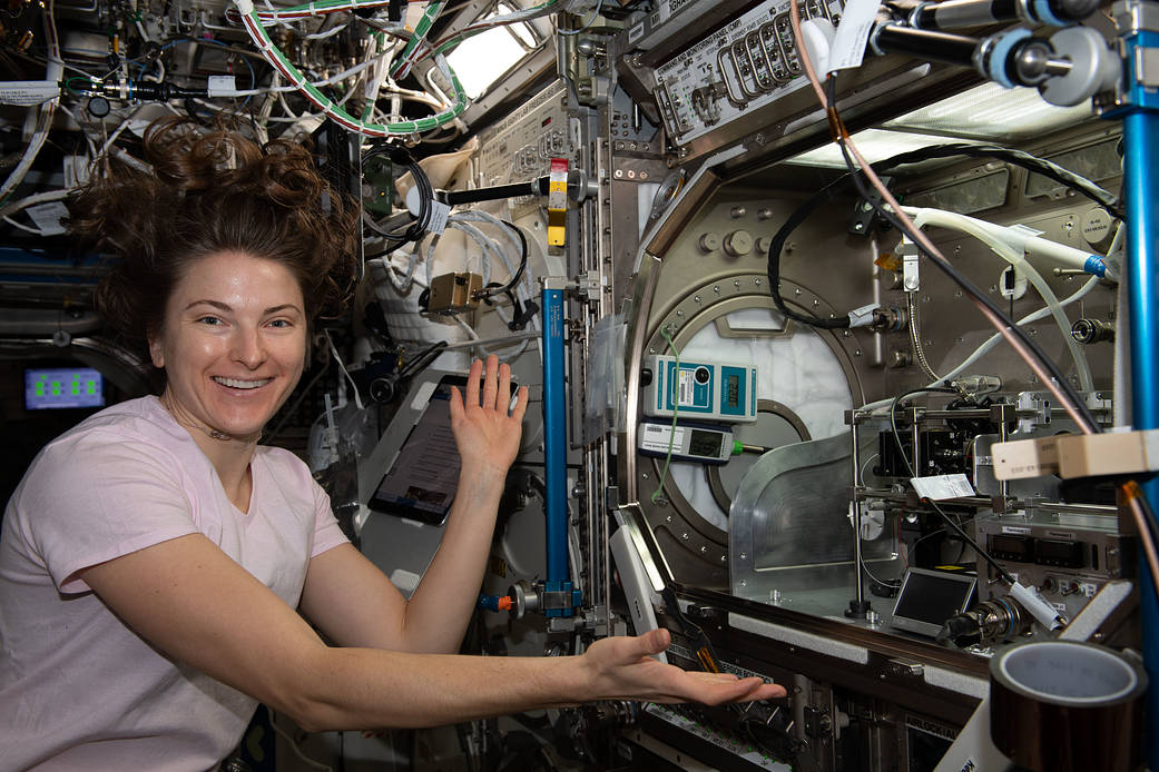 Astronaut Kayla Barron sets up hardware for the Intelligent Glass Optics study