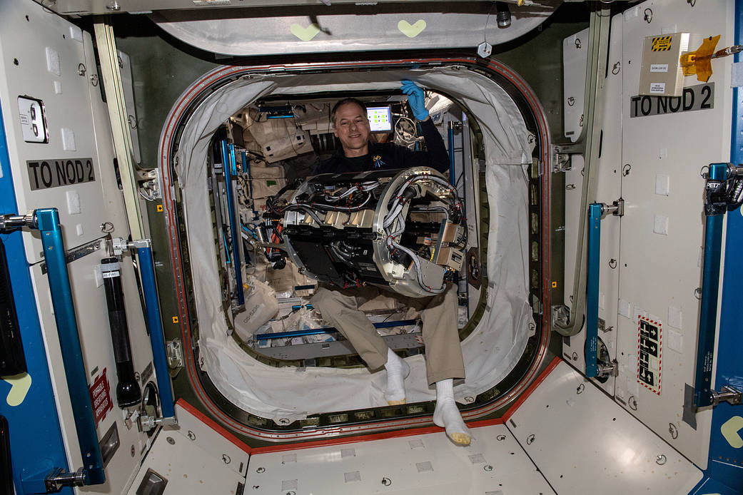 NASA astronaut Tom Marshburn carries the Combustion Chamber