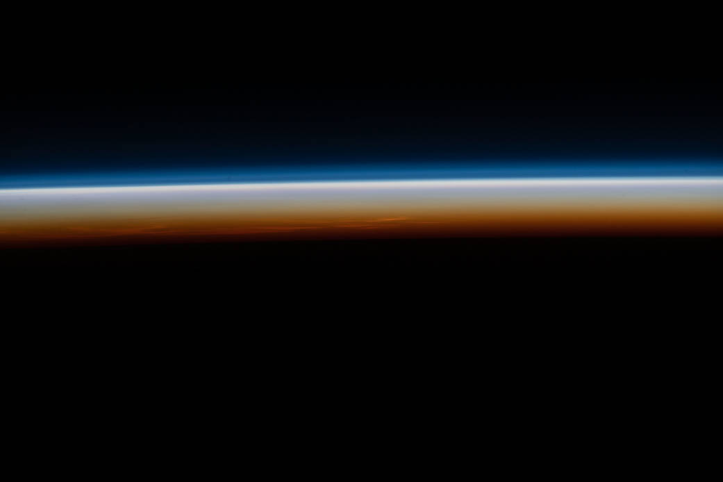 The last rays of an orbital sunset illuminate Earth's horizon