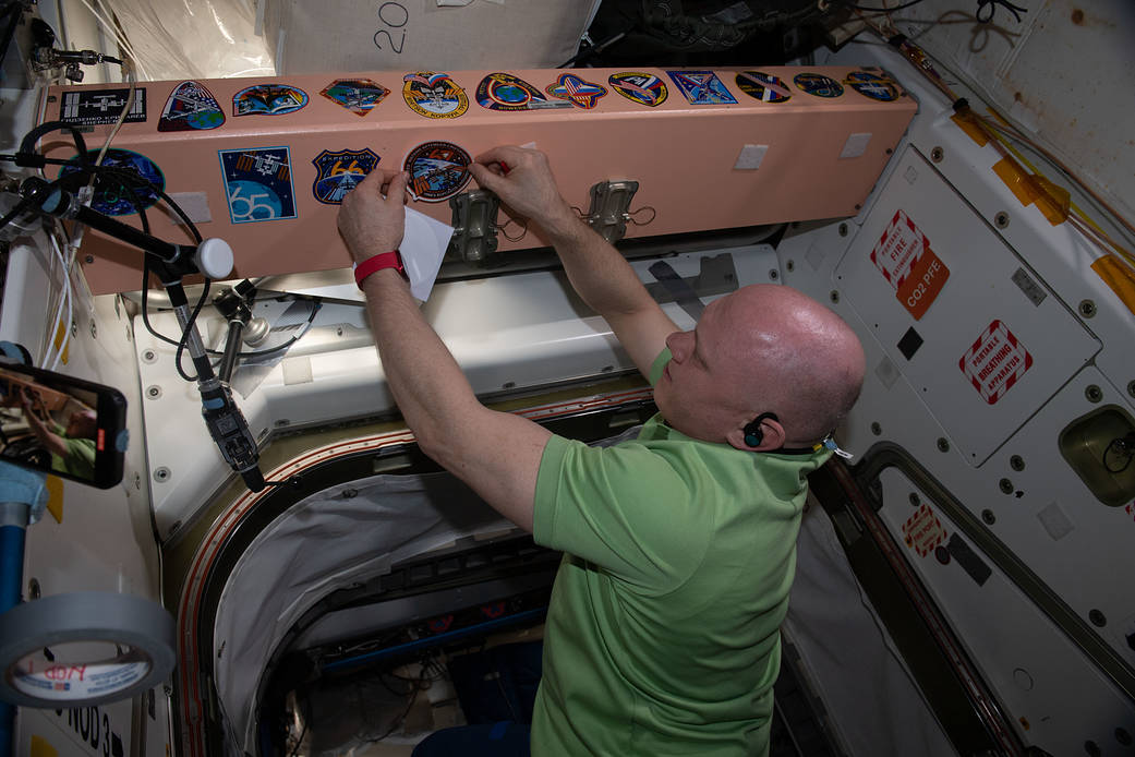 Cosmonaut Oleg Artemyev places his mission's sticker in the station
