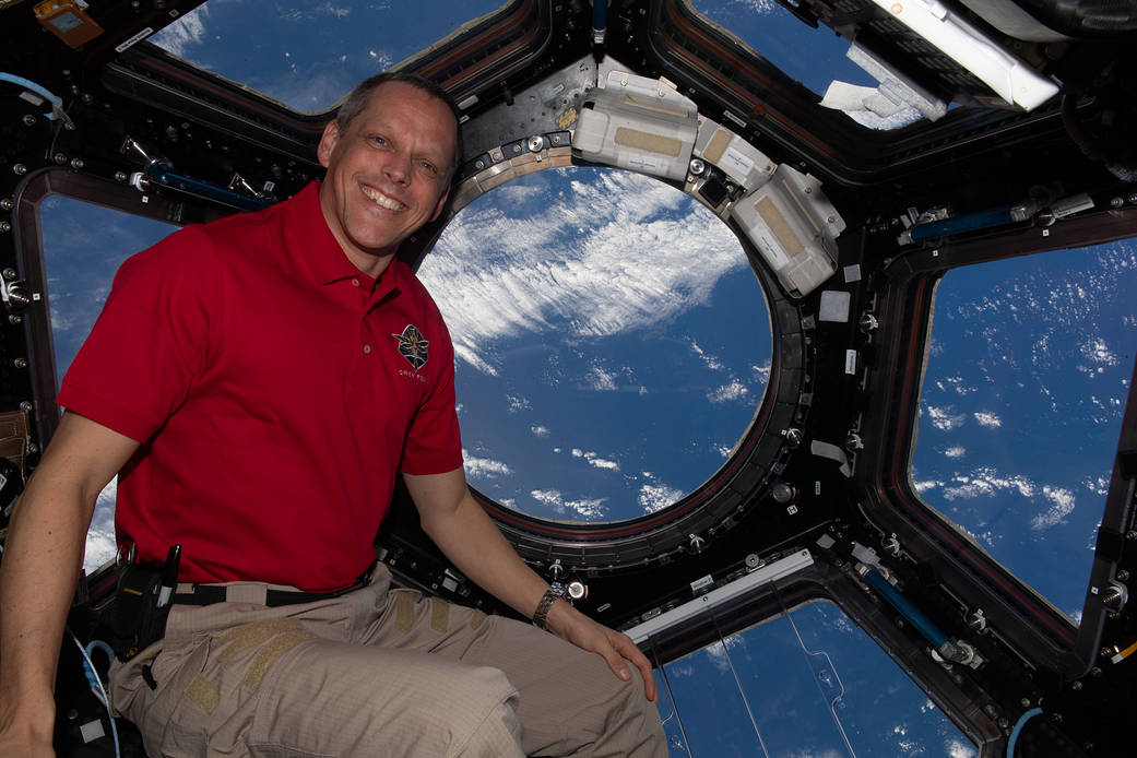Astronaut Bob Hines looks at the Earth through the cupola