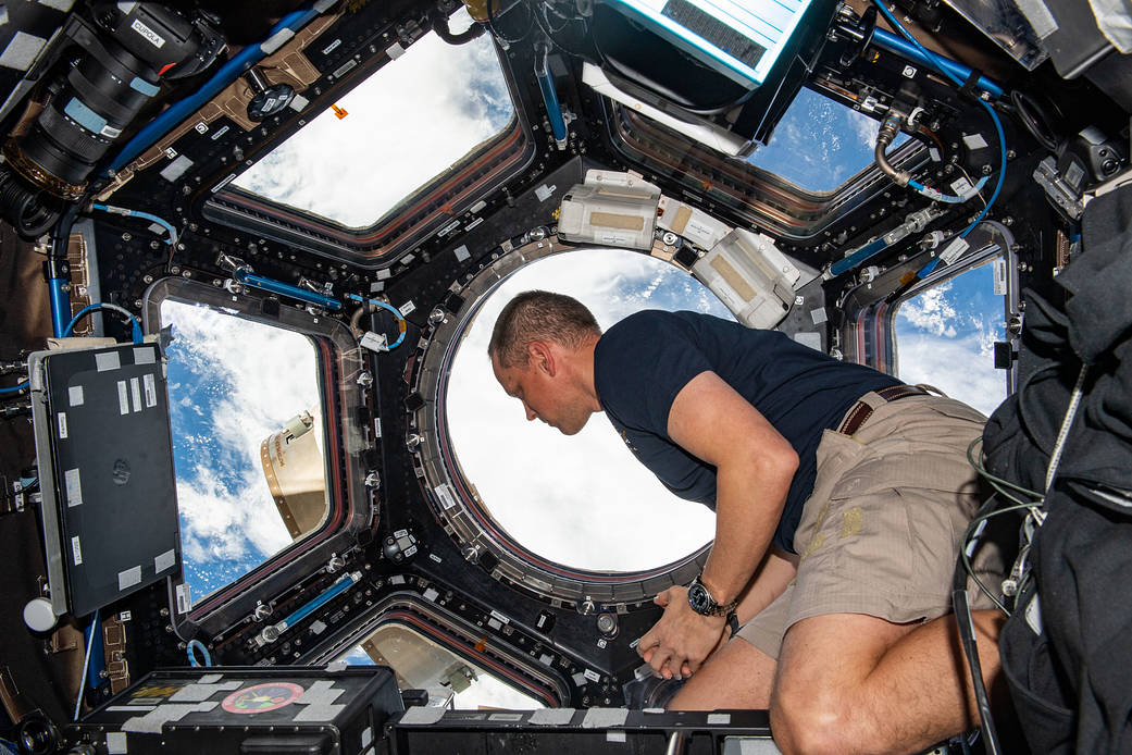 Astronaut Bob Hines is pictured looking at the Earth below