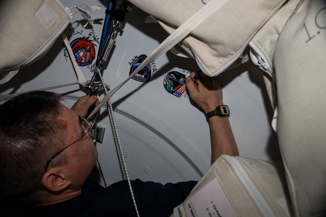 Astronaut Kjell Lindgren signs his name on the Harmony module