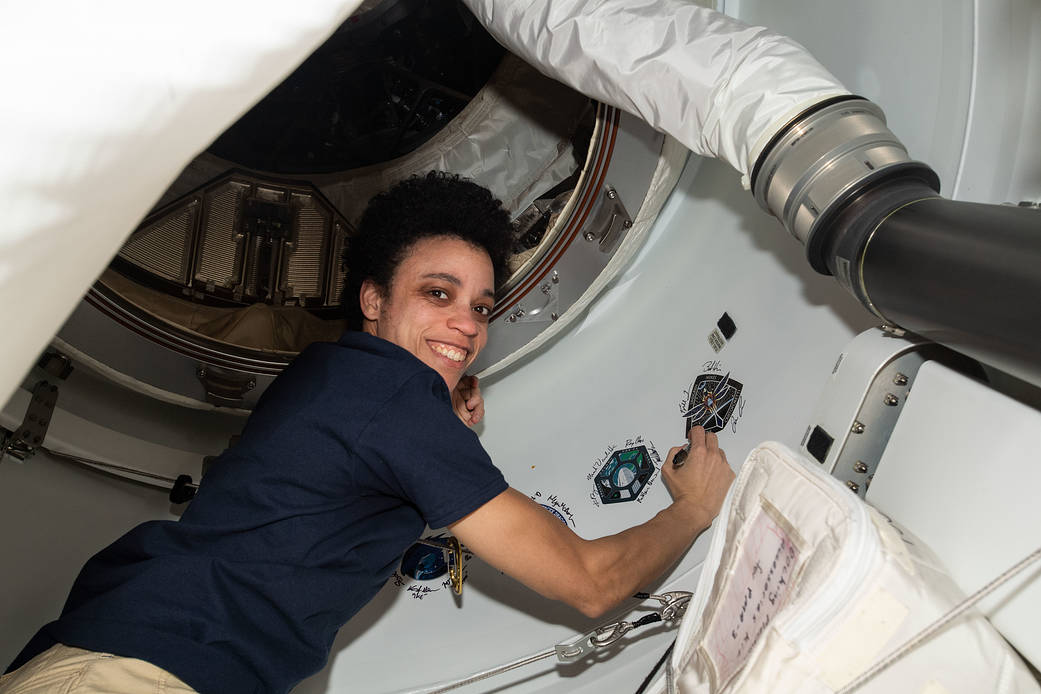 Astronaut Jessica Watkins signs her name around the Crew-4 sticker