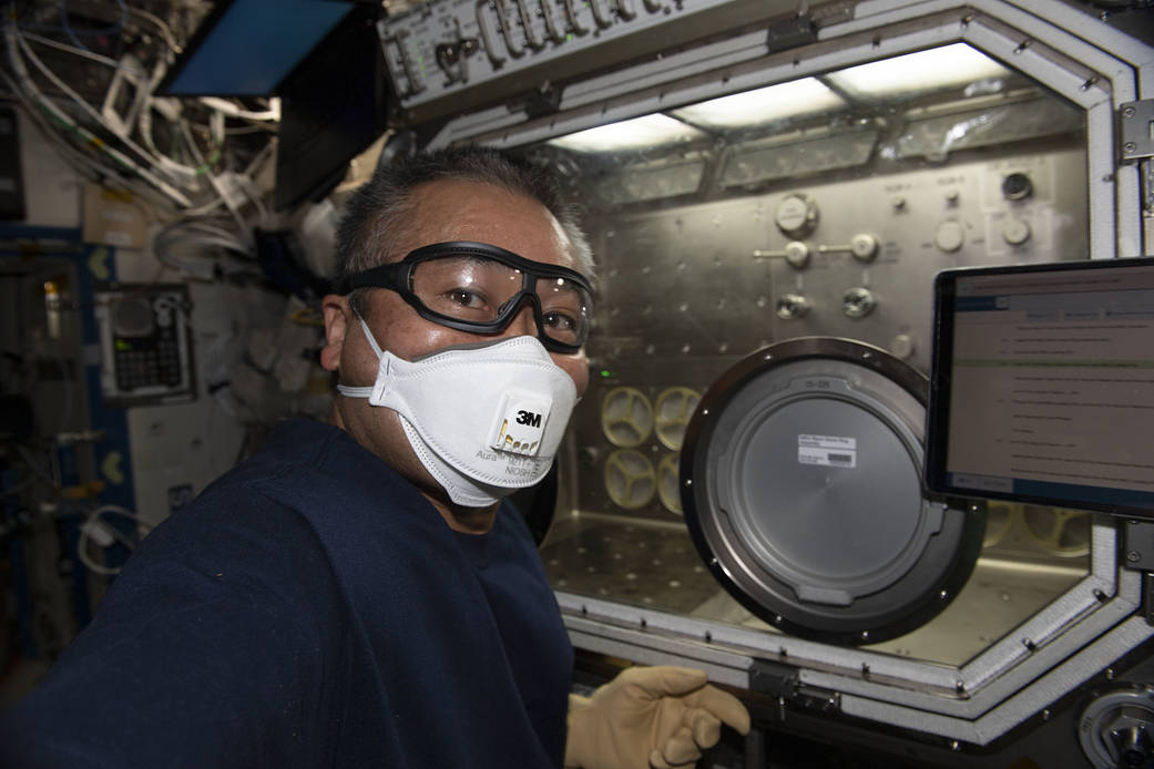Astronaut Koichi Wakata cleans the Microgravity Science Glovebox