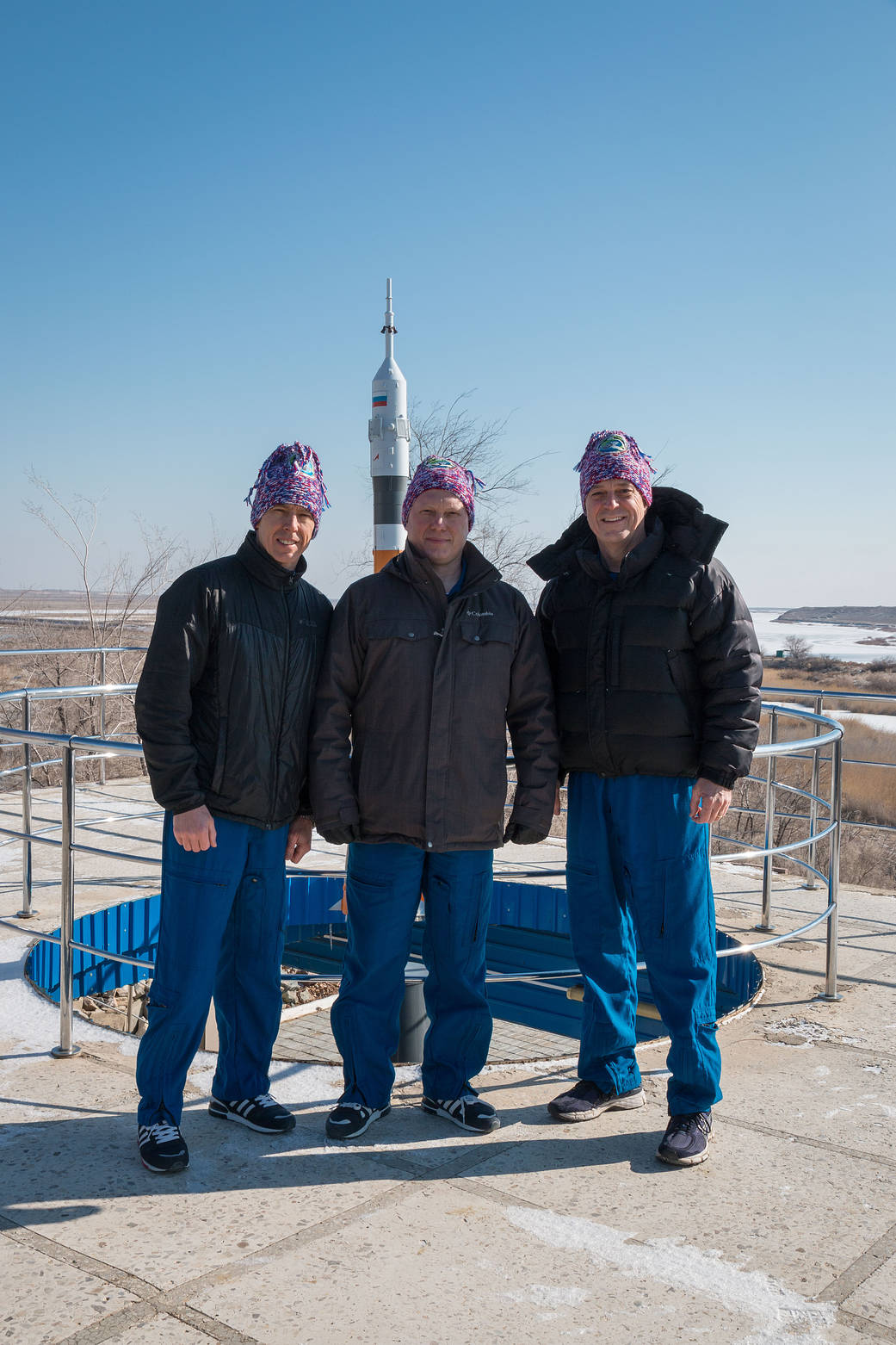 Expedition 55 Trio Pose in Front of Soyuz Model