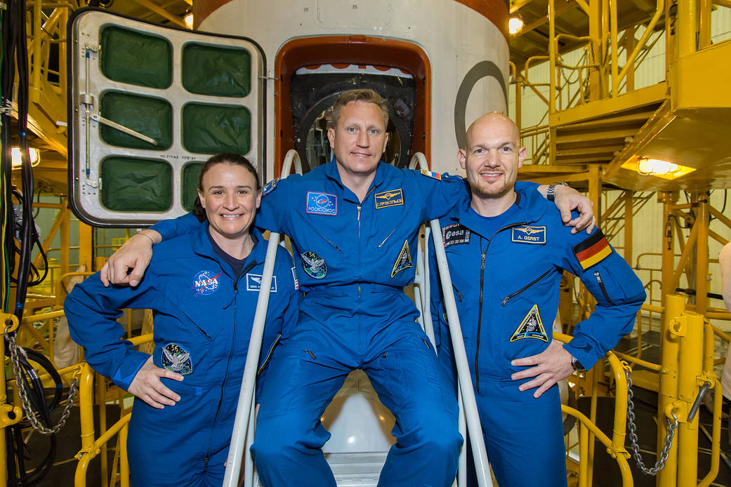 Expedition 56 crew members in front of the Soyuz spacecraft