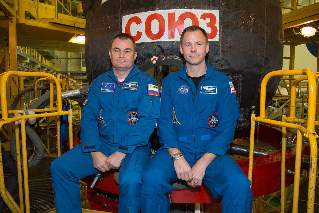 Expedition 57 crew members Alexey Ovchinin and Nick Hague pose in front of their Soyuz MS-10 spacecraft