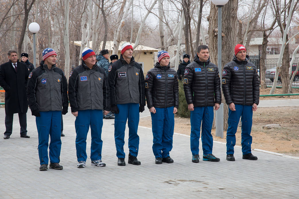 Expedition 58 prime and backup crew members attend a flag-raising ceremony