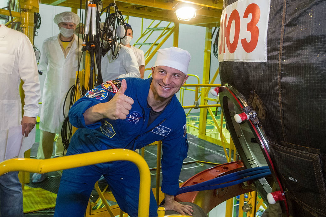 Expedition 60 crewmember Drew Morgan boards his Soyuz spacecraft