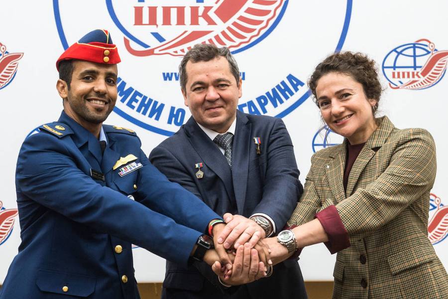 Spaceflight participant Hazzaa Ali Almansoori, Oleg Skripochka and Jessica Meir pose for pictures