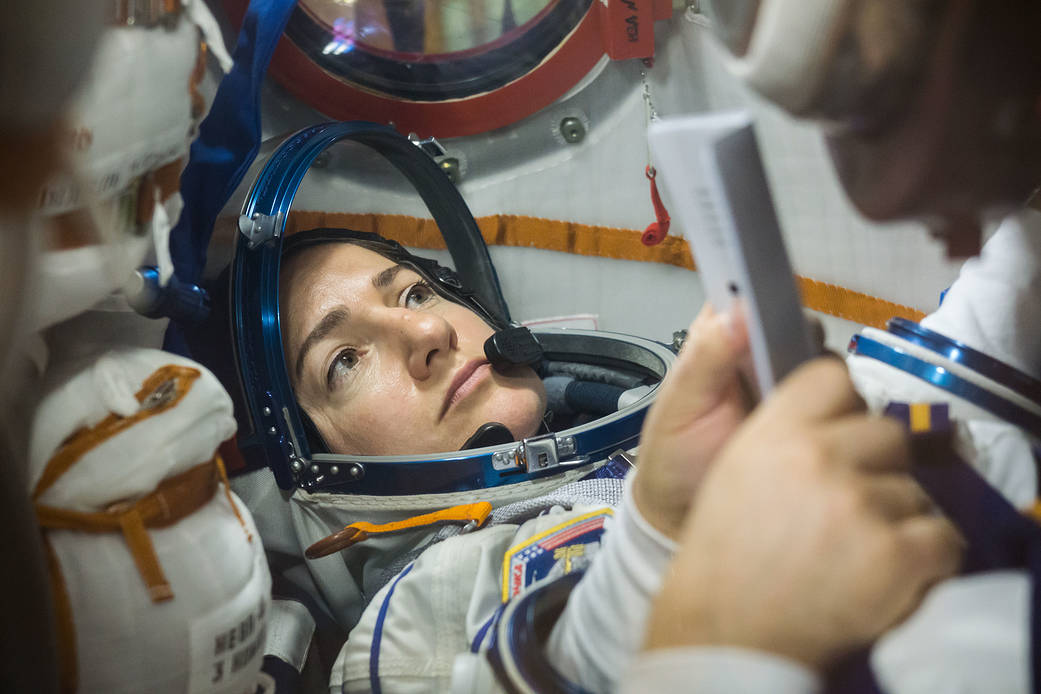 In the Integration Building at the Baikonur Cosmodrome in Kazakhstan, Expedition 61 crew member Jessica Meir of NASA runs through procedures Sept. 11 aboard the Soyuz MS-15 spacecraft during an initial Soyuz vehicle fit check. Credit: NASA/Victor Zelentsov