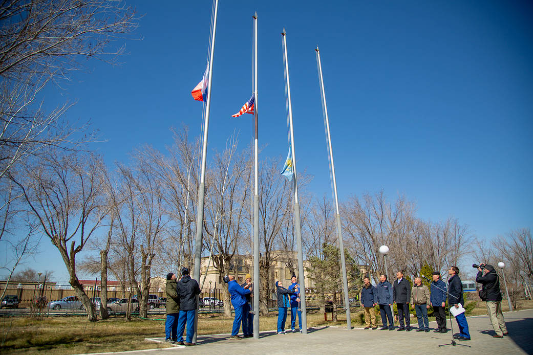 The Expedition 63 prime and backup crewmembers raise flags