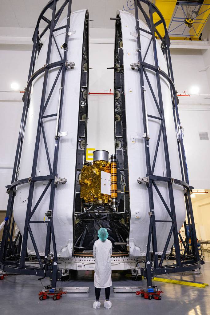 Inside SpaceX's Payload Processing Facility at Vandenberg Space Force Base in California, both halves of the Falcon 9 rocket's protective payload fairing move toward NASA's Double Asteroid Redirection Test (DART) spacecraft.