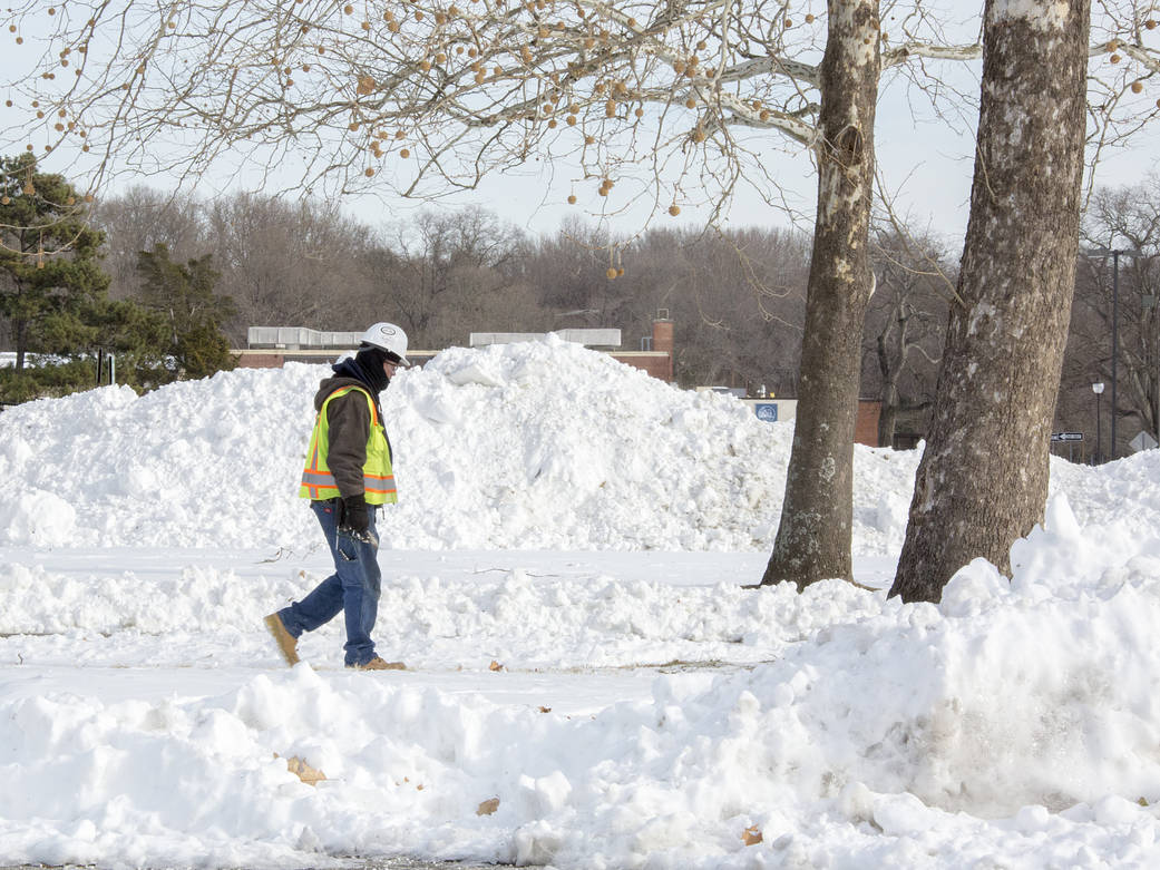 A construction worker passes by a snow pile Jan. 8 as NASA Langley crews clean up after a snow storm.