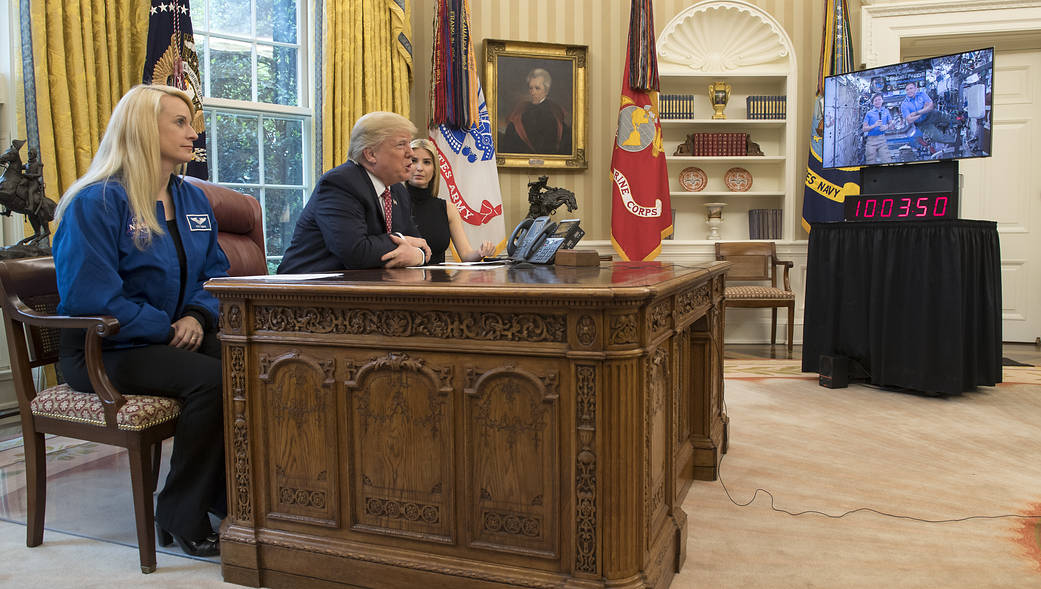President Trump, Ivanka Trump and astronaut Kate Rubins at desk in Oval Office