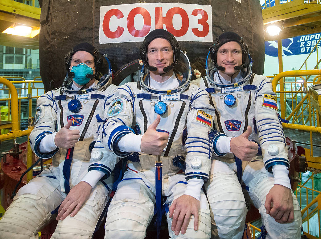 Expedition 64 crew members (from left) Kate Rubins of NASA and Sergey Ryzhikov and Sergey Kud-Sverchkov of Roscosmos in front of the Soyuz MS-17 spacecraft.