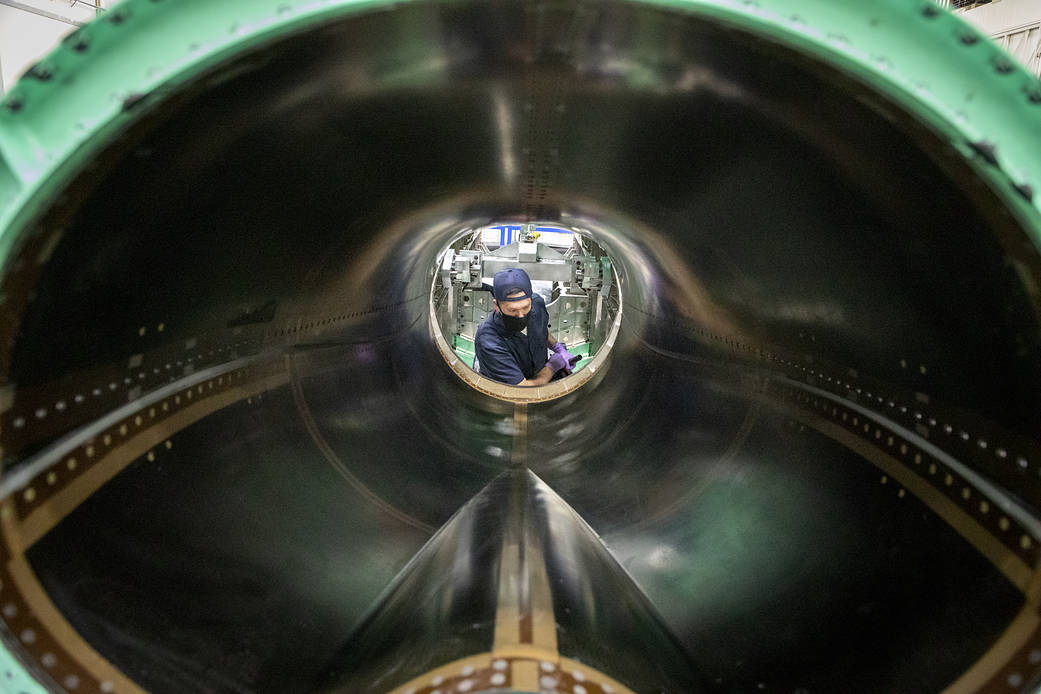 A technician works on the engine inlet of NASA’s X-59 Quiet Supersonic Technology 