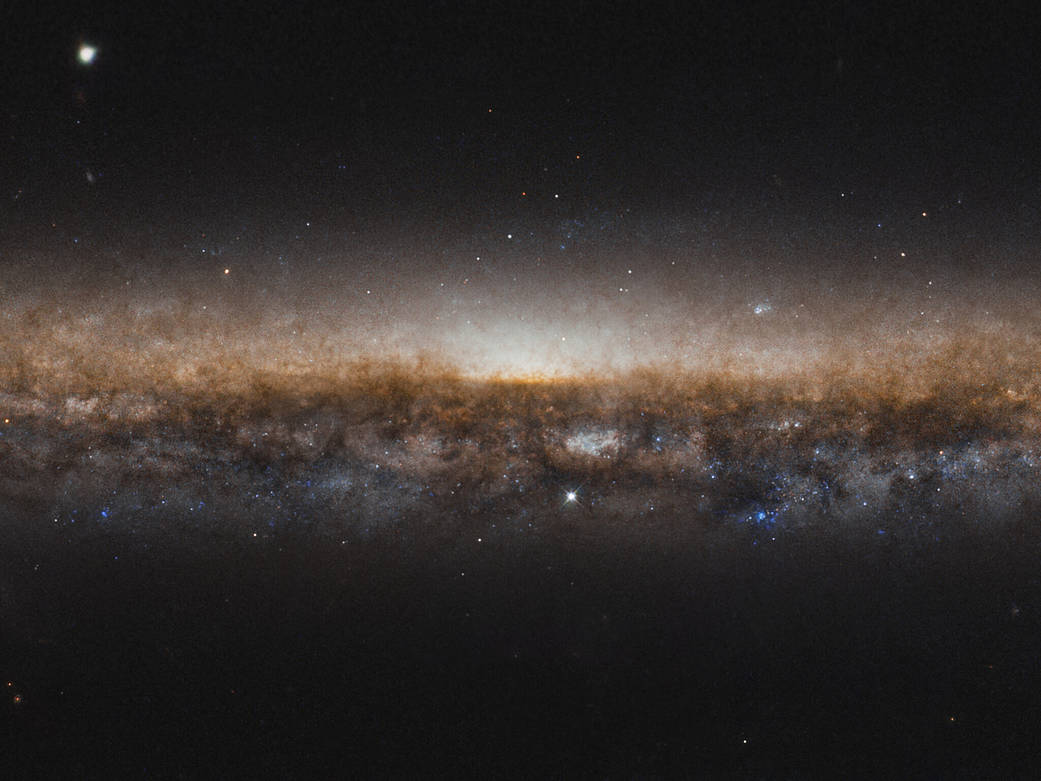 edge-on view of the stars in galaxy NGC 5907, bright against the backdrop of space