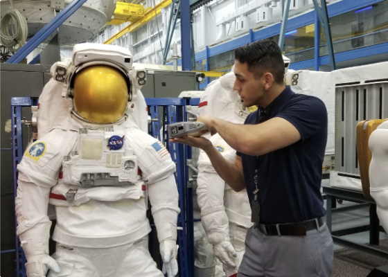 Pathways Intern looking at NASA Space Suit