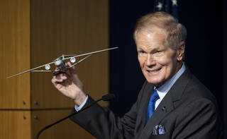 NASA Administrator Bill Nelson holds a model of an aircraft with a Transonic Truss-Braced Wing during a news conference on NASA’s Sustainable Flight Demonstrator project on Jan. 18.