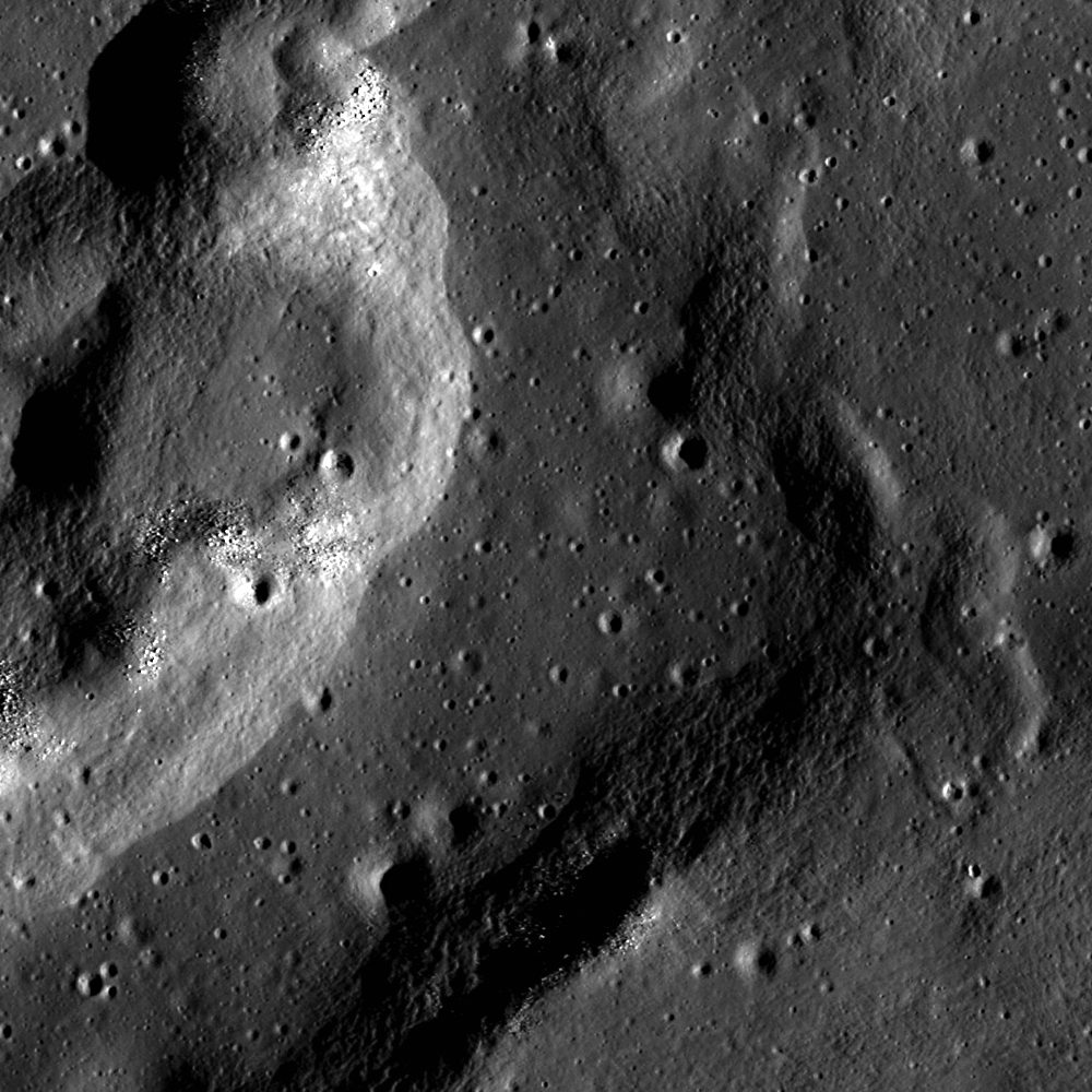 A complex wrinkle ridge in Mare Crisium at low Sun, seen in an image captured by the Lunar Reconaissance Orbiter Camera (illumination is from the right). Image width is 700 m, north is up. Boulders occupy the tops of mounds on the west ridge, and the central depression is more heavily cratered than the ridge.