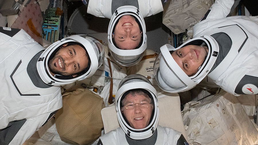 Four Expedition 69 flight engineers aboard the International Space Station pose for a portrait in the pressure suits they will wear when they relocate the SpaceX Dragon Endeavour crew ship.