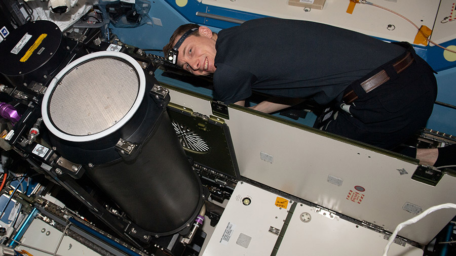 Astronaut Woody Hoburg works replaces life support system components inside the International Space Station's Destiny laboratory module.