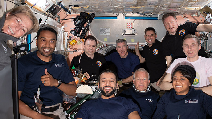 The Axiom Mission-2 (Ax-2) and Expedition 69 crew members pose for a portrait together aboard the space station. In the center front row, is Expedition 69 crew member Sultan Alneyadi flanked by (from left) Ax-2 crew mates Peggy Whitson, Ali Alqarni, John Shoffner, and Rayyanah Barnawi. In the back (from left) are, Expedition 69 crew mates Dmitri Petelin, Stephen Bowen, Andrey Fedyaev, Sergey Prokopyev, and Woody Hoburg. Not pictured is astronaut Frank Rubio.