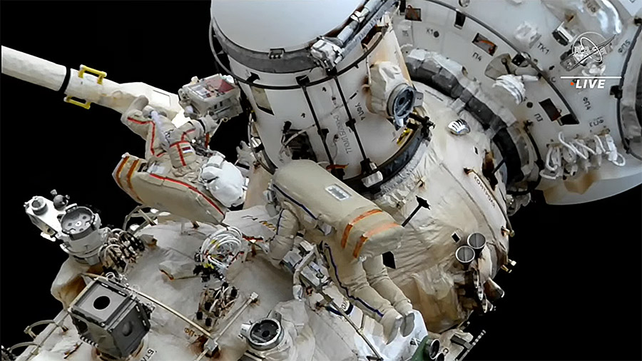 Spacewalkers Sergey Prokopyev and Dmitri Petelin work outside the space station to install an experiment module on the Nauka science module with assistance from the European robotic arm. Credit: NASA TV