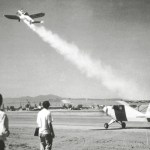 Men watching plane take off.