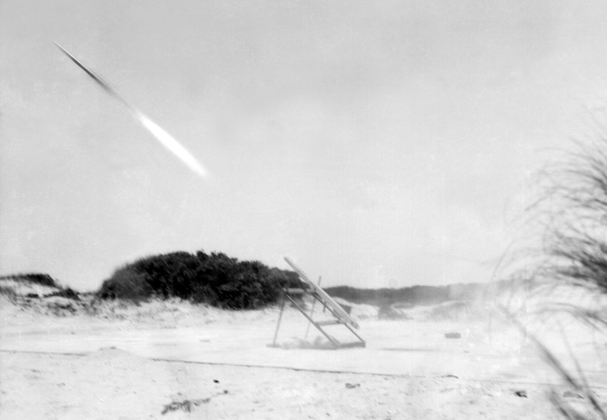 Small rocket launch on beach.