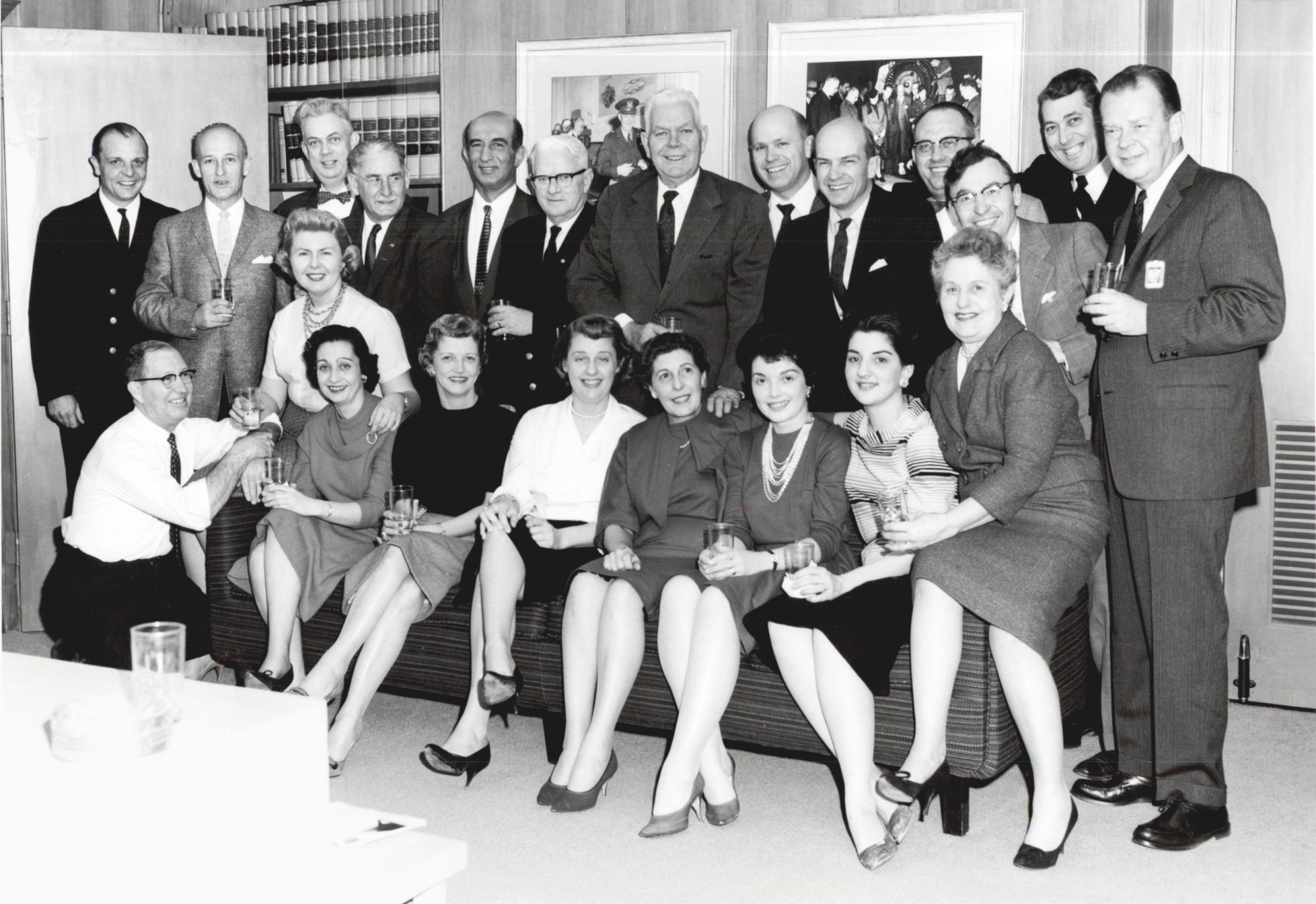 Men and women posing for group photograph.